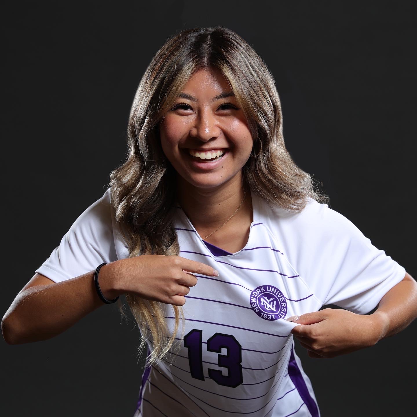 Allison Cao in her NYU soccer jersey